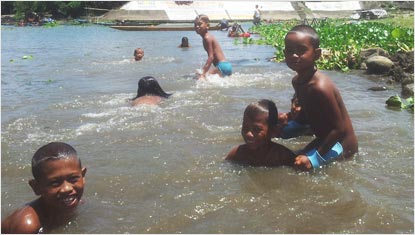 Kids in the water near Pagsanjan Falls, Philippines